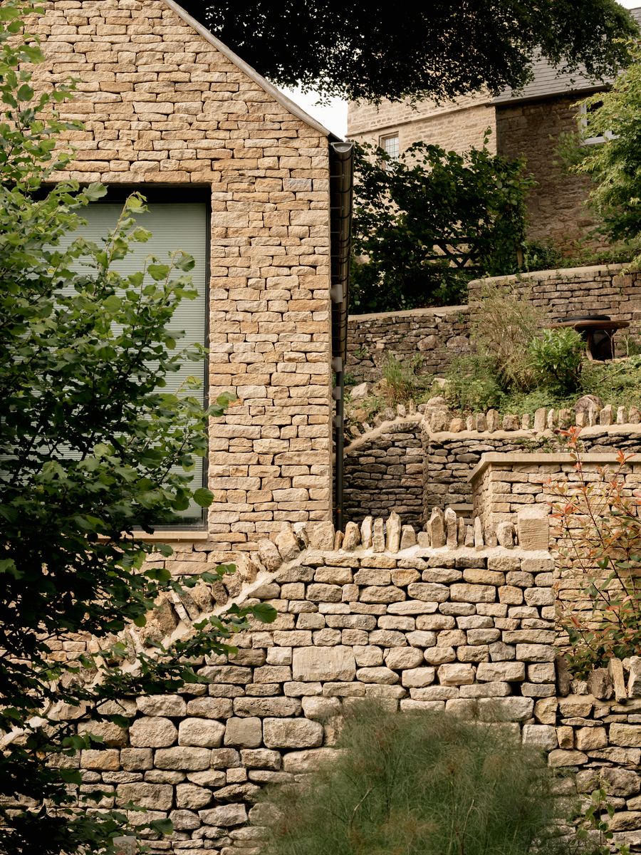 Cotswold Cottage Extension new dry-stone gable meeting terraced garden walls with stone coping